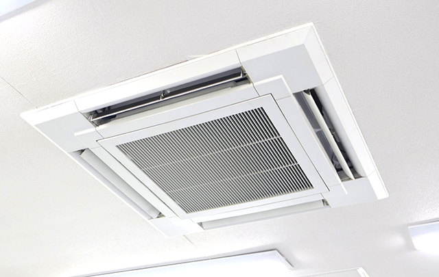 オフィスの天井に据え付けられた大型のエアコンの画像