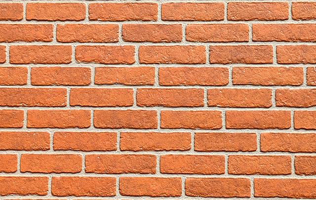 きれいにパターン化して並べられたレンガの壁面の画像