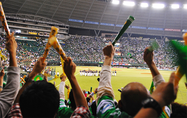 野球を応援している人たちを背後から見た画像