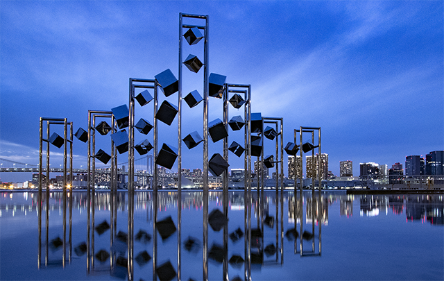 夜の藍色に染まる風で揺れ動くオブジェの画像